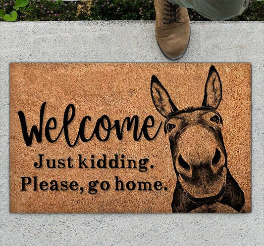 Bienvenido, es broma, vete a casa. Felpudo divertido con forma de burro