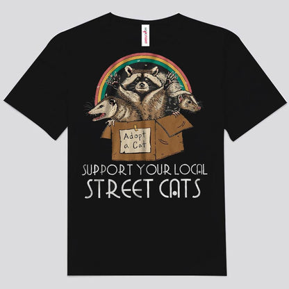 Camisetas de mapache arcoíris con el logo de "Apoya a tus gatos callejeros locales"