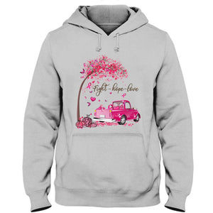 Camiseta con el lema "Lucha, esperanza, amor", árbol y coche con lazo rosa, para concienciar a los supervivientes del cáncer de mama